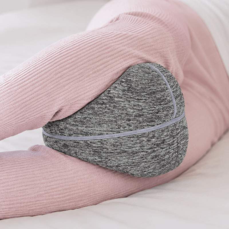 Side sleeper with the ComfortCurve knee pillow held between the knees by its elastic strap