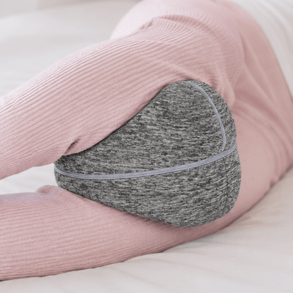 Side sleeper with the ComfortCurve knee pillow held between the knees by its elastic strap