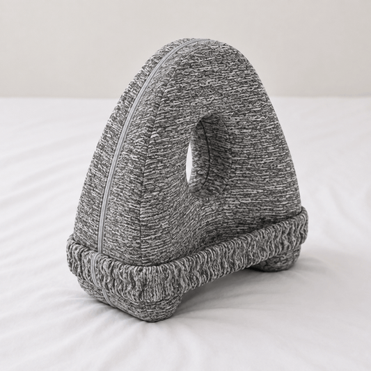 EverComfort ComfortCurve knee pillow in grey knit, standing on a made bed